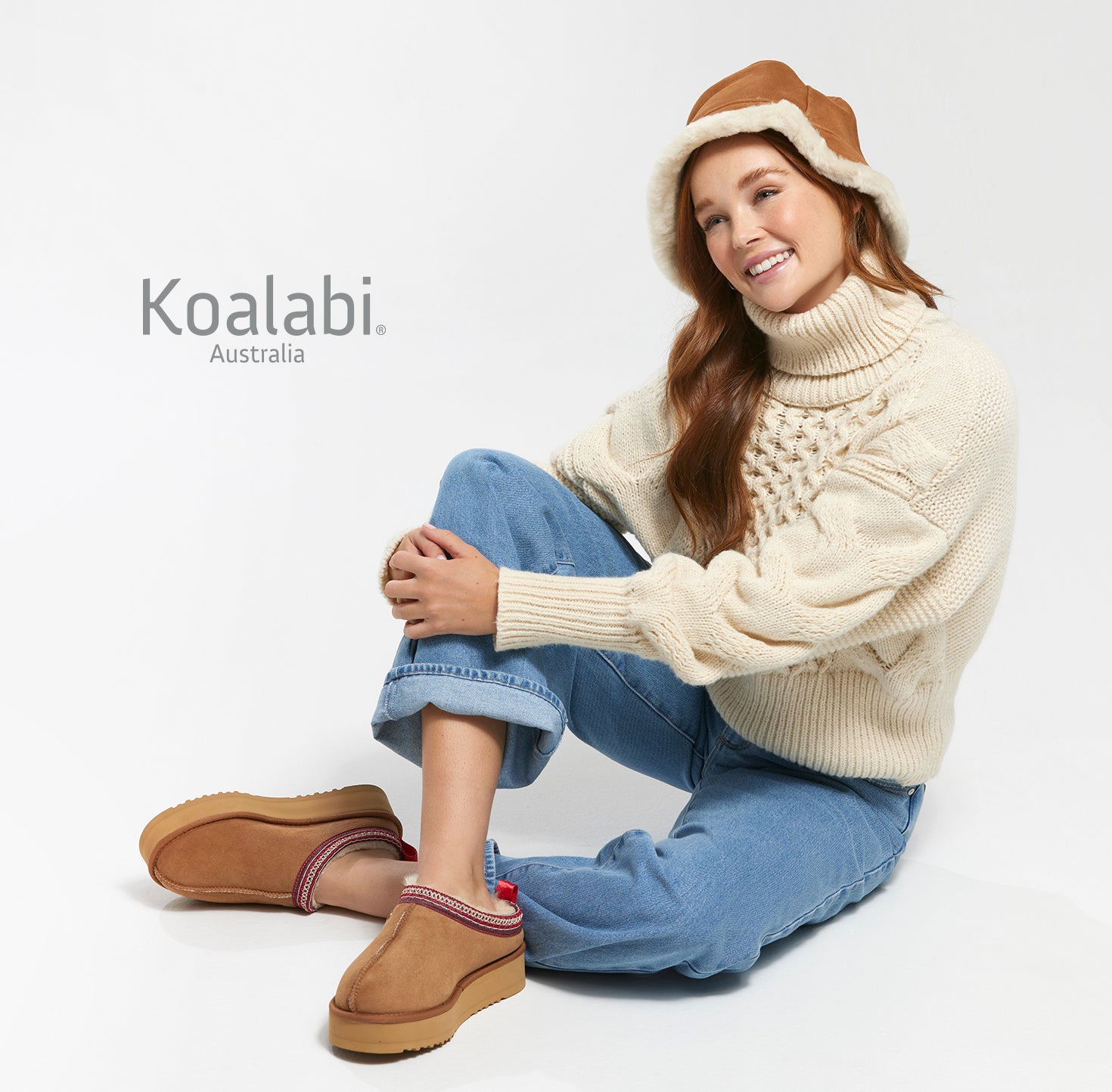 Woman wearing Jasper Platform boots with braided trim, styled with denim jeans.